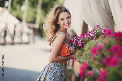 Portrait of a pretty woman next to vases of flowers