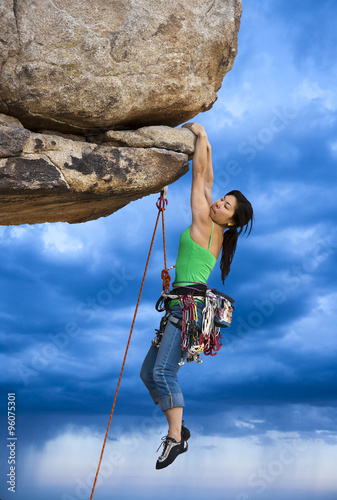 Rock climber clinging to a cliff.