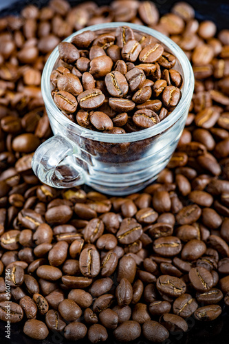 Fototapeta Naklejka Na Ścianę i Meble -  Coffee beans(Arabica) roasted in a espresso cup.