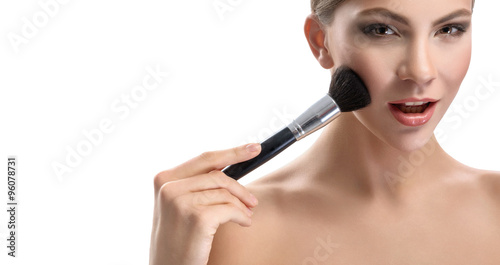 Beauty portrait of a woman on a white background with a brush