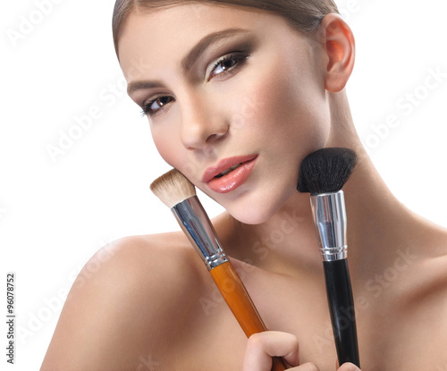 Beauty portrait of a woman on a white background with a brush