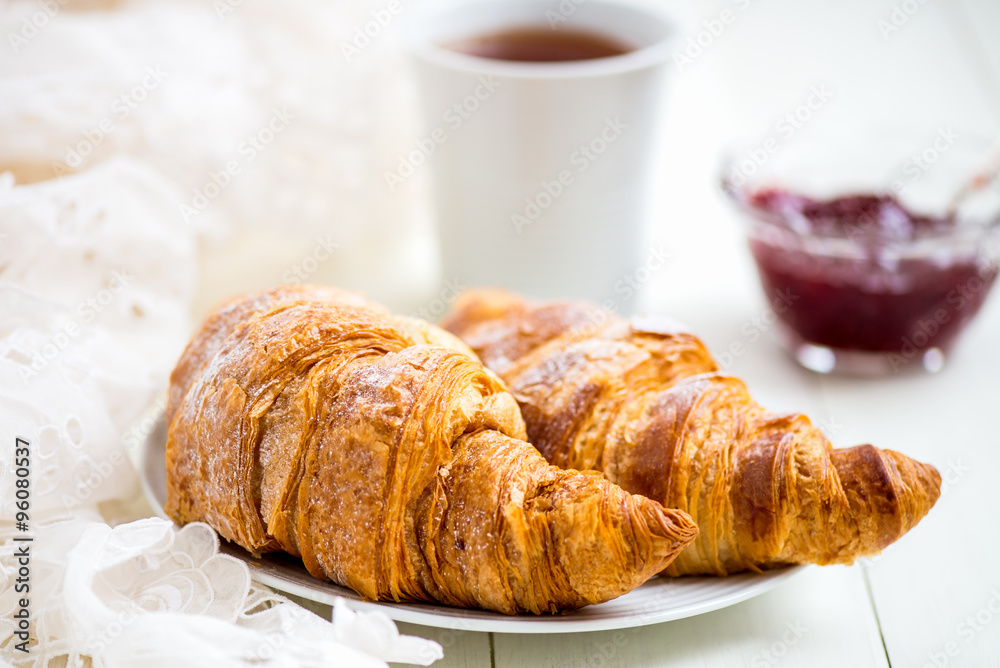 Fresh Croissants with Icing, Cup of Tea and Strawberry Jam Fresh Croissants with Icing, Cup of Tea and Strawberry Jam