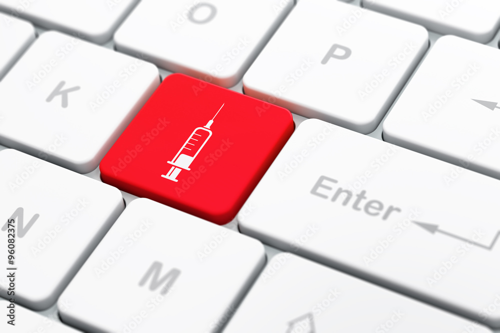 Medicine concept: Syringe on computer keyboard background Medicine concept: Syringe on computer keyboard background