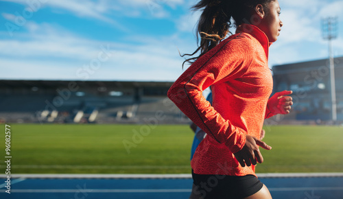 Fototapeta Naklejka Na Ścianę i Meble -  African female athlete training on race track