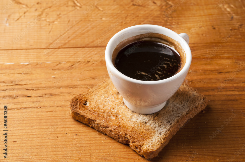 Coffee cup of espresso with toast on wooden table Coffee cup of espresso with toast on wooden table