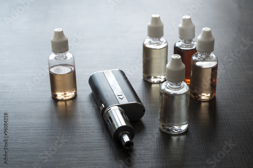 E-cigarettes with lots of different re-fill bottles photo