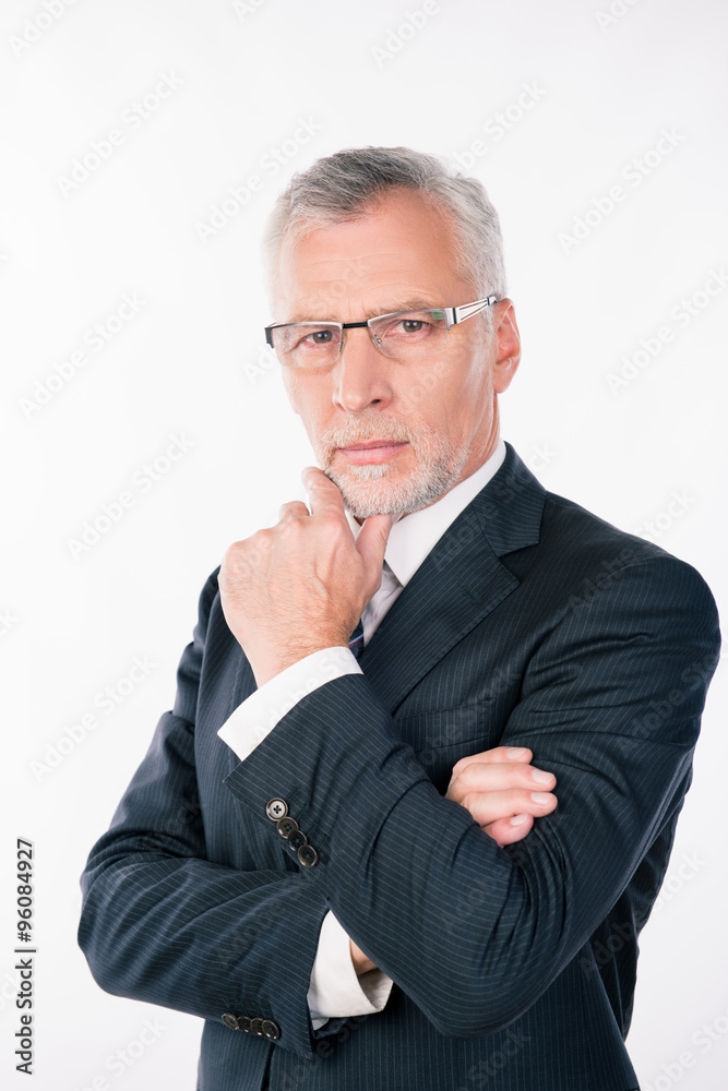 Portrait of intelligent businessman with gray beard pondering an