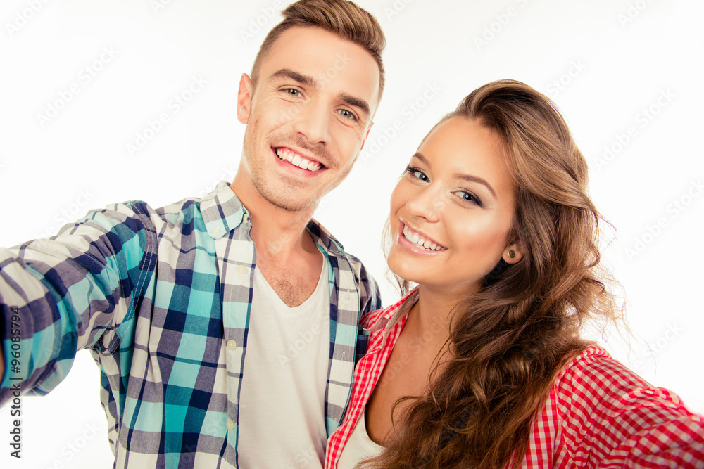 Cheerful pretty couple in love making selfie Cheerful pretty couple in love making selfie