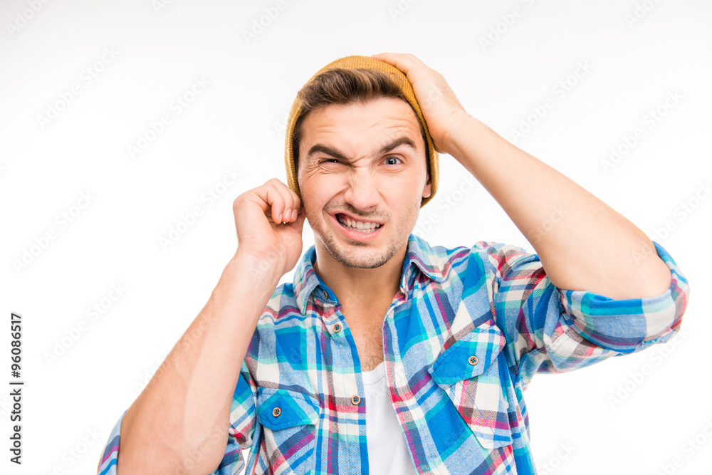 Handsome man with hat feeling uncomfortable Handsome man with hat feeling uncomfortable