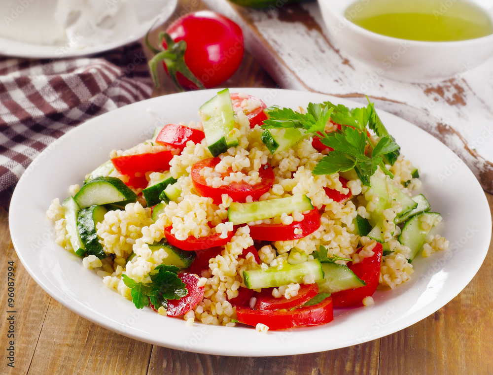 Tabbouleh salad with bulgur, parsley and vegetables Tabbouleh salad with bulgur, parsley and vegetables