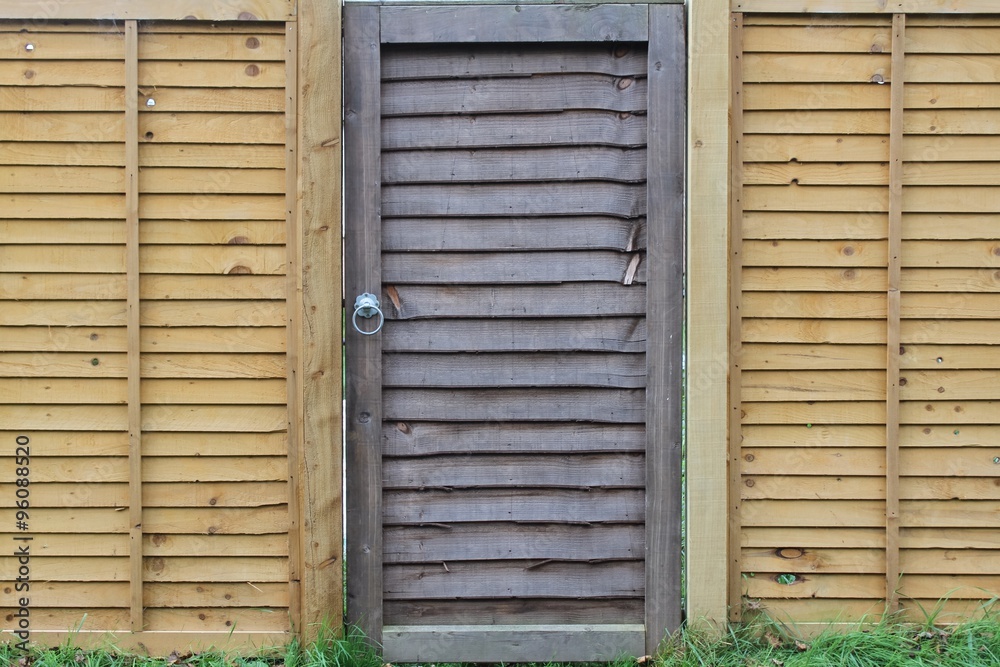 Mismatch wooden gate and fence