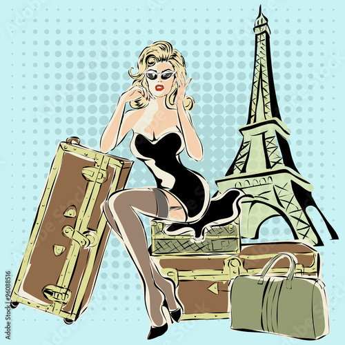 Beautiful pin-up woman sitting on suitcases near Eiffel Tower Paris