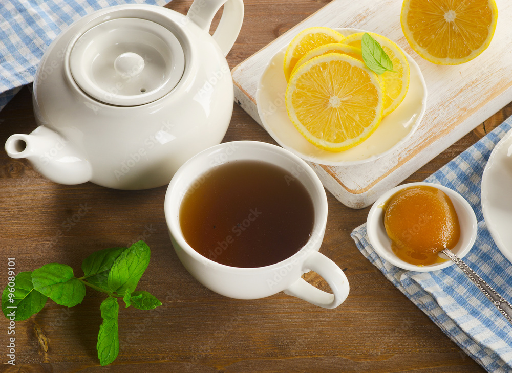 Teapot and cup with tea with lemon Teapot and cup with tea with lemon