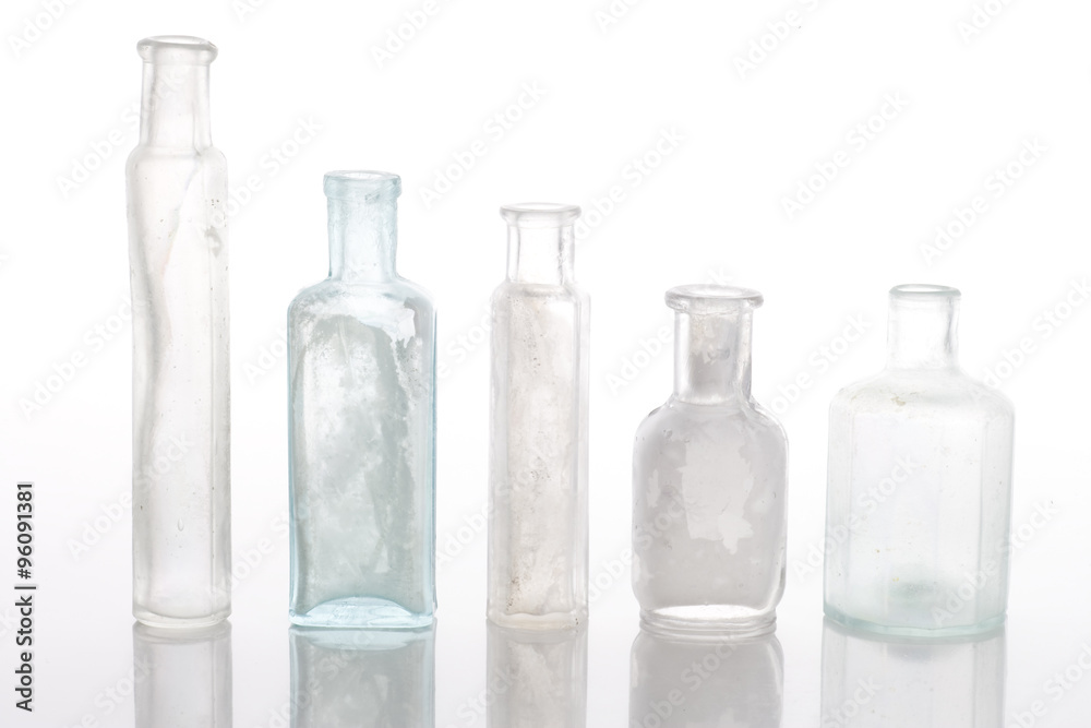 Antique bottles on white table Antique bottles on white table