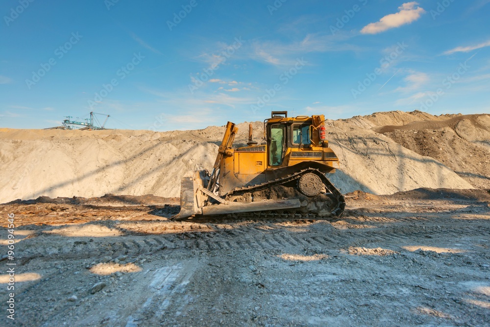 Excavation site with construction machine Excavation site with construction machine