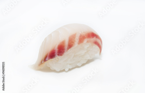 plate of sushi beautifully decorated with salad and fruit on a white background
