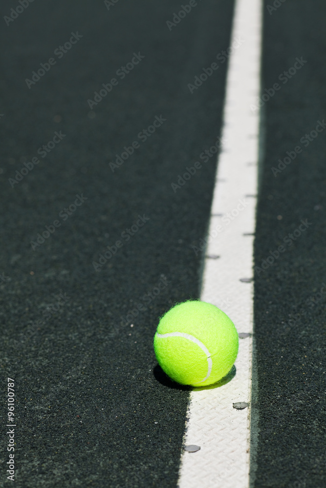 tennis ball on serve line of court