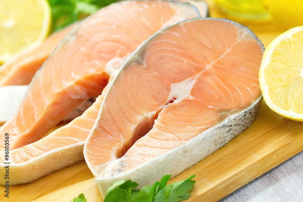 Raw fish with vegetables, lemon and oil prepared for cooking Raw fish with vegetables, lemon and oil prepared for cooking