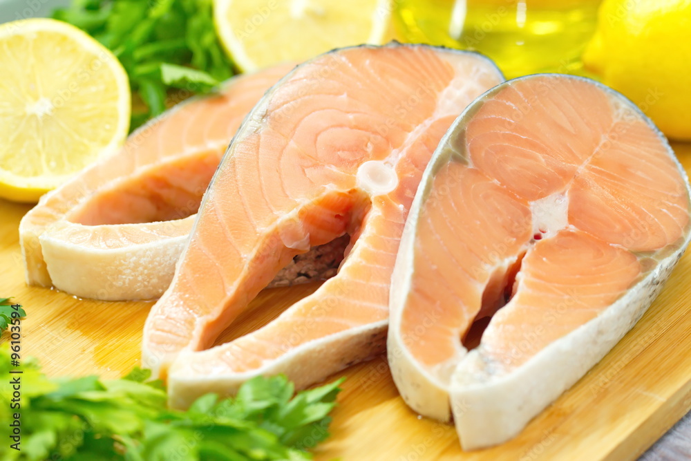 Raw fish with vegetables, lemon and oil prepared for cooking Raw fish with vegetables, lemon and oil prepared for cooking