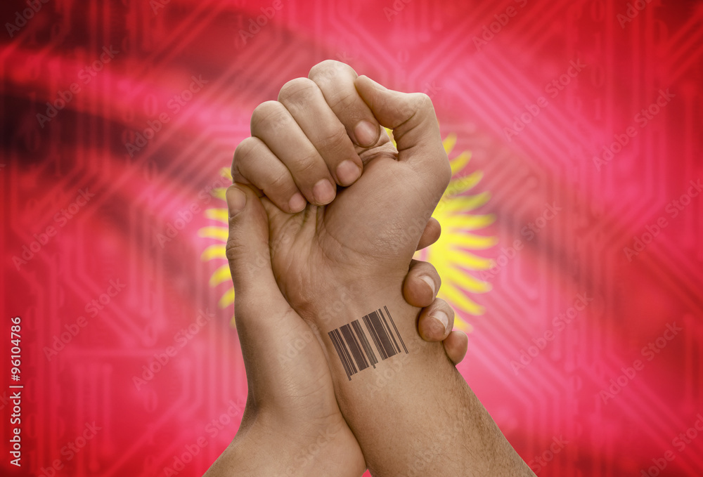 Barcode ID number on wrist of dark skinned person and national flag on background - Kyrgyzstan