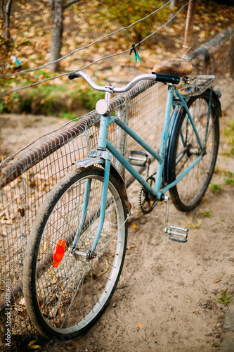 Parked vintage old bicycle bike in courtyard.