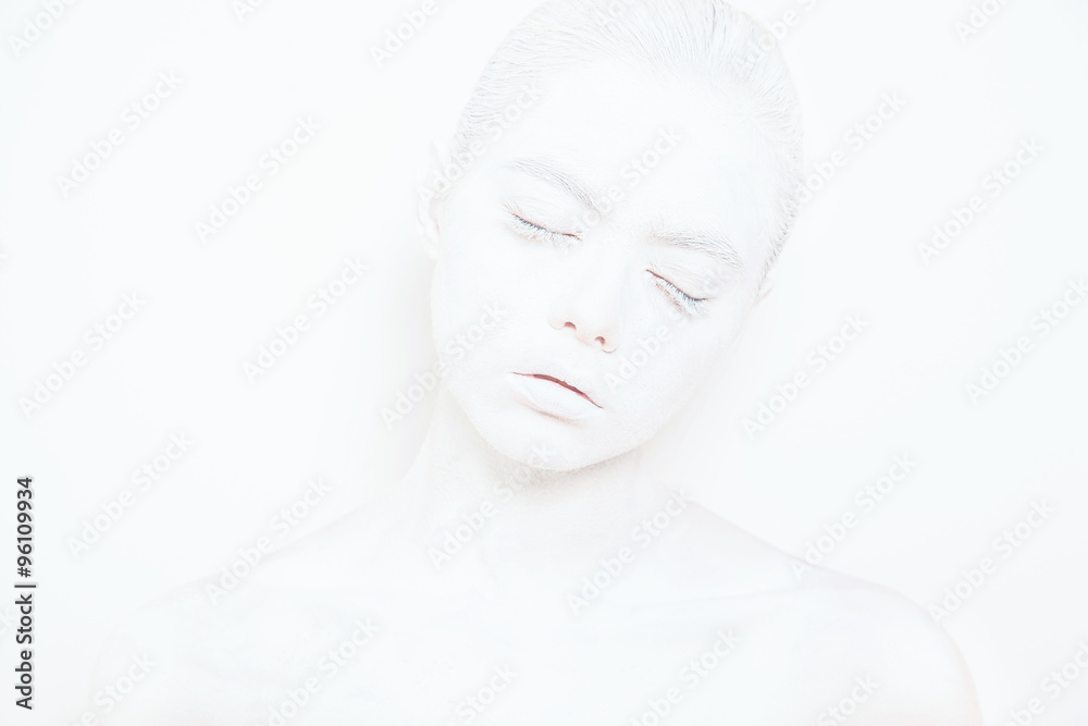 Girl with White Paint on the Skin on a White Background