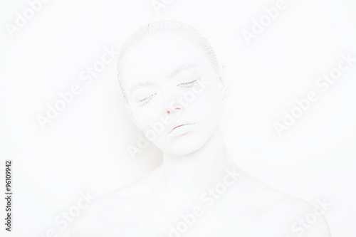 Girl with White Paint on the Skin on a White Background