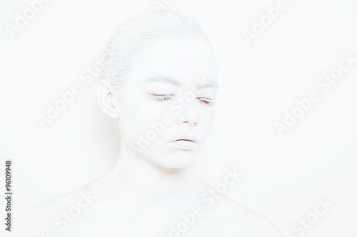 Girl with White Paint on the Skin on a White Background