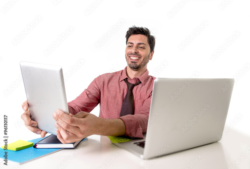 businessman working at office desk using digital tablet pad smiling happy sitting in front of computer laptop looking satisfied businessman working at office desk using digital tablet pad smiling happy sitting in front of computer laptop looking satisfied