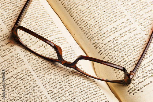 Old book with glasses