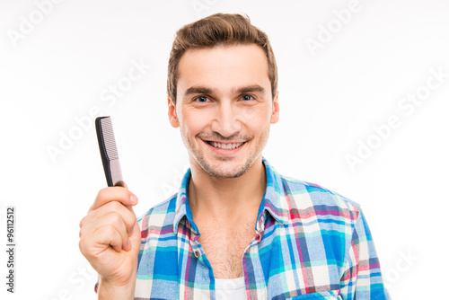 Handsome young man holding a comb