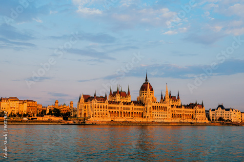 Hungarian Parliament on river at sunset, Budapest. Construction started building in 1885 and completed in 1904.