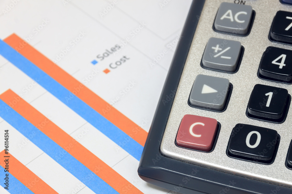 Selective focus calculator on sales,cost chart document. Selective focus calculator on sales,cost chart document.