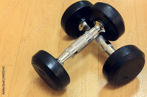 dumbbells on wood background.