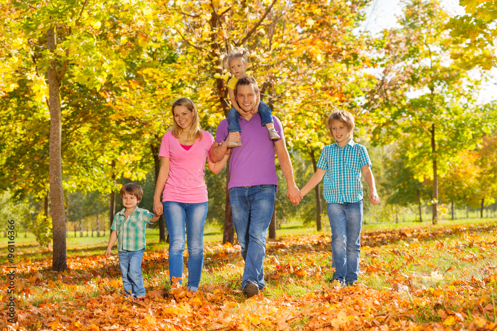 Parents and kids walking together holding hands Parents and kids walking together holding hands