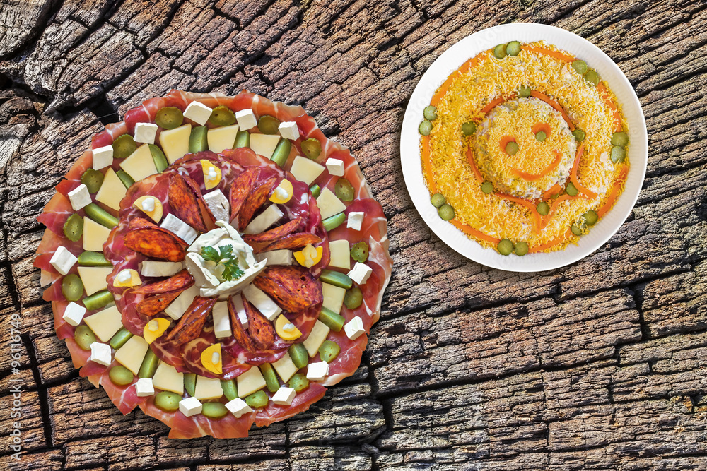 Plateful of Savory Appetizer Meze, with Bowl of Russian Salad, on Old, Cracked, Stump Cracked Surface. Plateful of Savory Appetizer Meze, with Bowl of Russian Salad, on Old, Cracked, Stump Cracked Surface.
