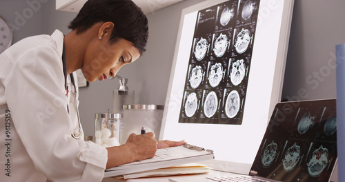 African medical woman reading x-ray results of a brain