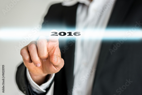 Closeup of male finger activating a 2016 sign on a virtual scree