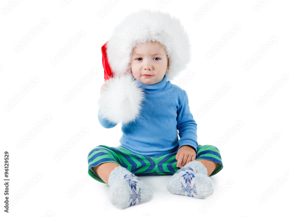 Cute little boy in the red furry Santa hat on white background Cute little boy in the red furry Santa hat on white background