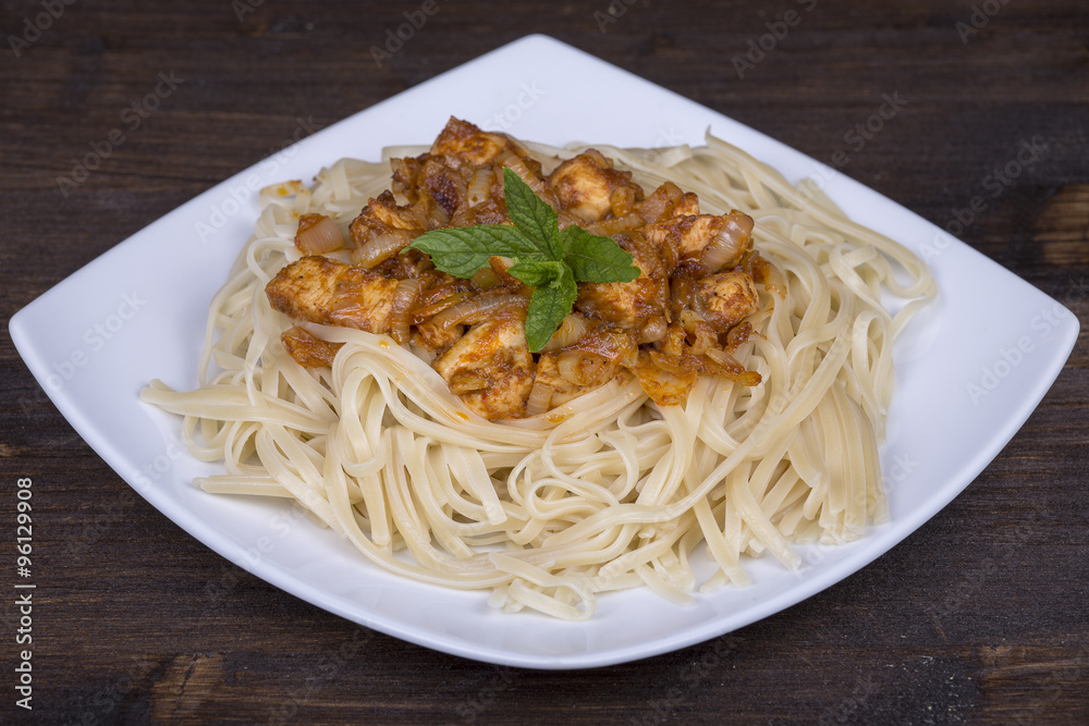 Spaghetti with chicken and vegetable on a plate