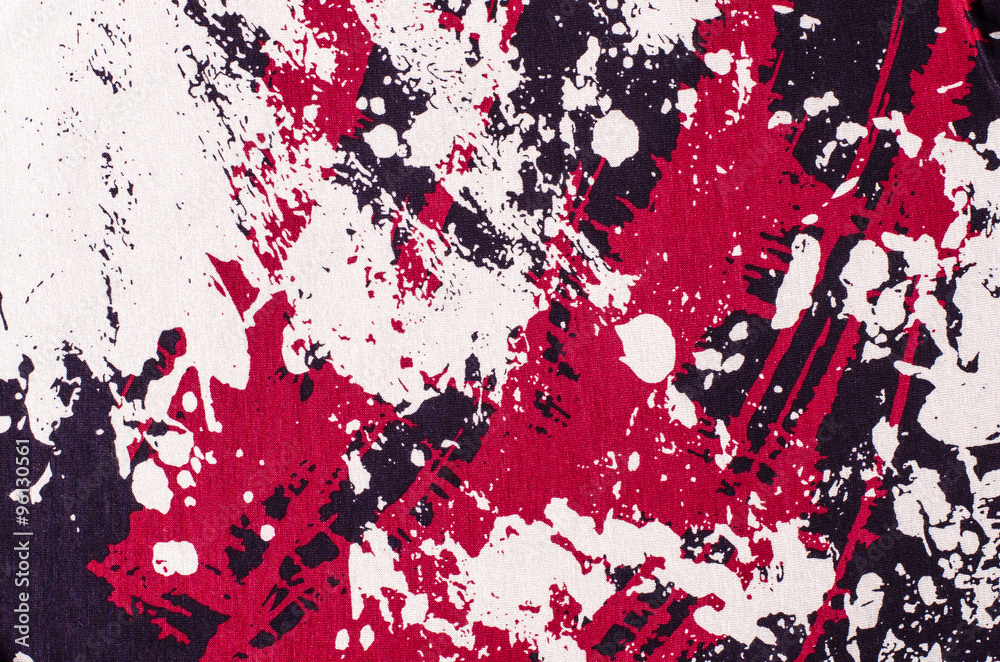 Abstract shapes pattern on gray fabric. Purple and red with grey stained material as background.