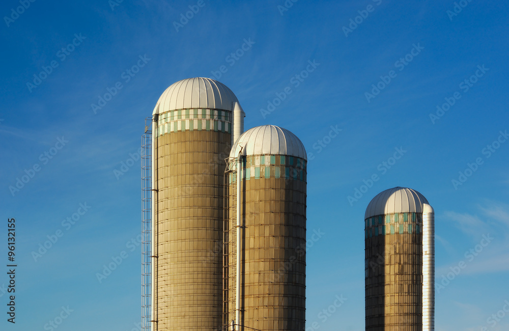 three farm silos on blue sky country building rural tank three farm silos on blue sky country building rural tank