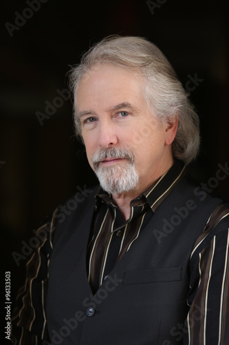 Headshot portrait mature male model against black background photo