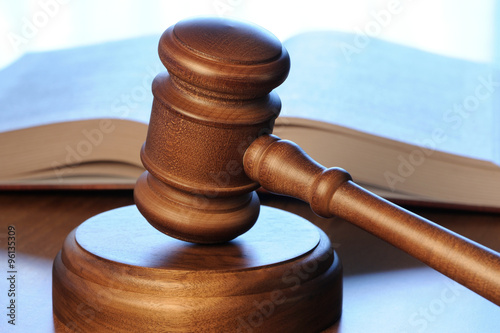 Gavel and opened book on wood table