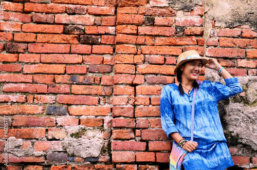 Thai woman portrait at Brick wall Background of Wat Yai chaimong