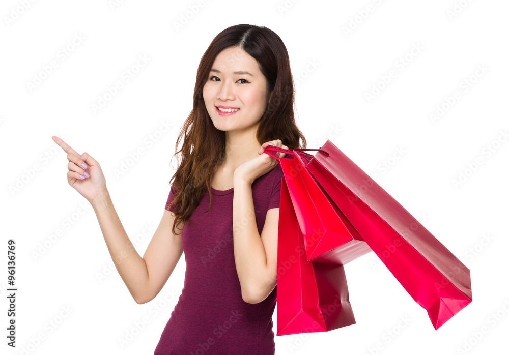 Asian Woman hold with shopping bag and finger point up Asian Woman hold with shopping bag and finger point up