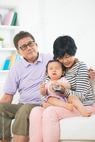 asian grand parents with crying grand daugther