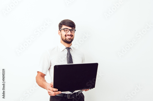 Portrait of an handsome businessman with a laptop