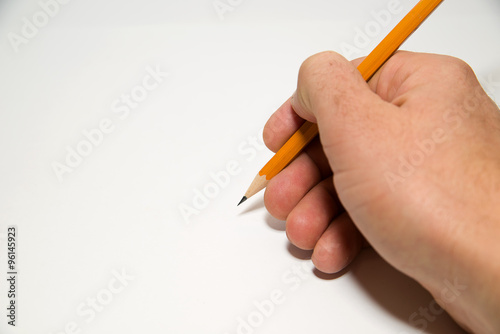 Men's right hand holding a pencil on over white