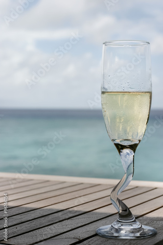 A champagne glass by the ocean